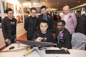 A Cintiq art demonstration held at the exhibition booth during the Malaysia Top 10 Outstanding Young Artists Awards while the Deputy Minister of Education and Higher Learning II, P. Kamalanathan looks on.