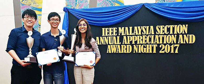 Dr Zuhaina Zakaria, past chair of IEEE Malaysia Section presenting award to Kong as Dr Lim looks on.