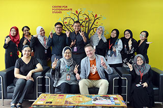 Caption: IUKL staff posing for a picture with the speaker, Prof. Dr Oliver Hahn after the lecture.
