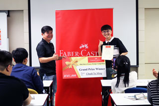 Grand Prize winner, Chuah Yu Ming, receiving his prize from Faber-Castell’s representative.