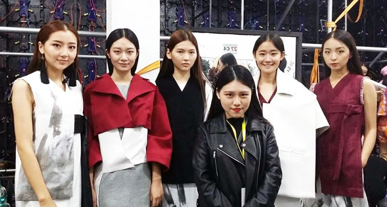 Tan Wan Yee posing with the models showcasing her designs.