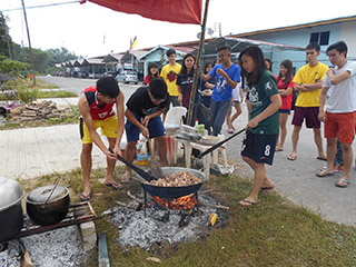 Helping out with food preparation at Rumah Ampik.