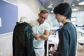 A student getting feedback on his design during Jury Week