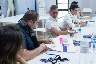 Panel of jury looking over student’s designs during Jury week