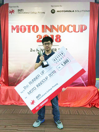 Phang posing with his trophy and mock cheque.